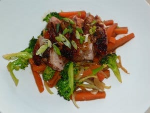 5 spice duck on a bed of stir fried vegetables