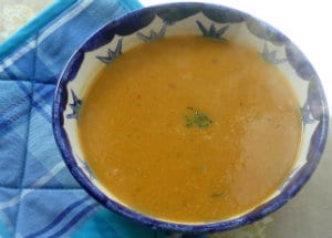 A steaming bowl of red onion & sweet potato soup