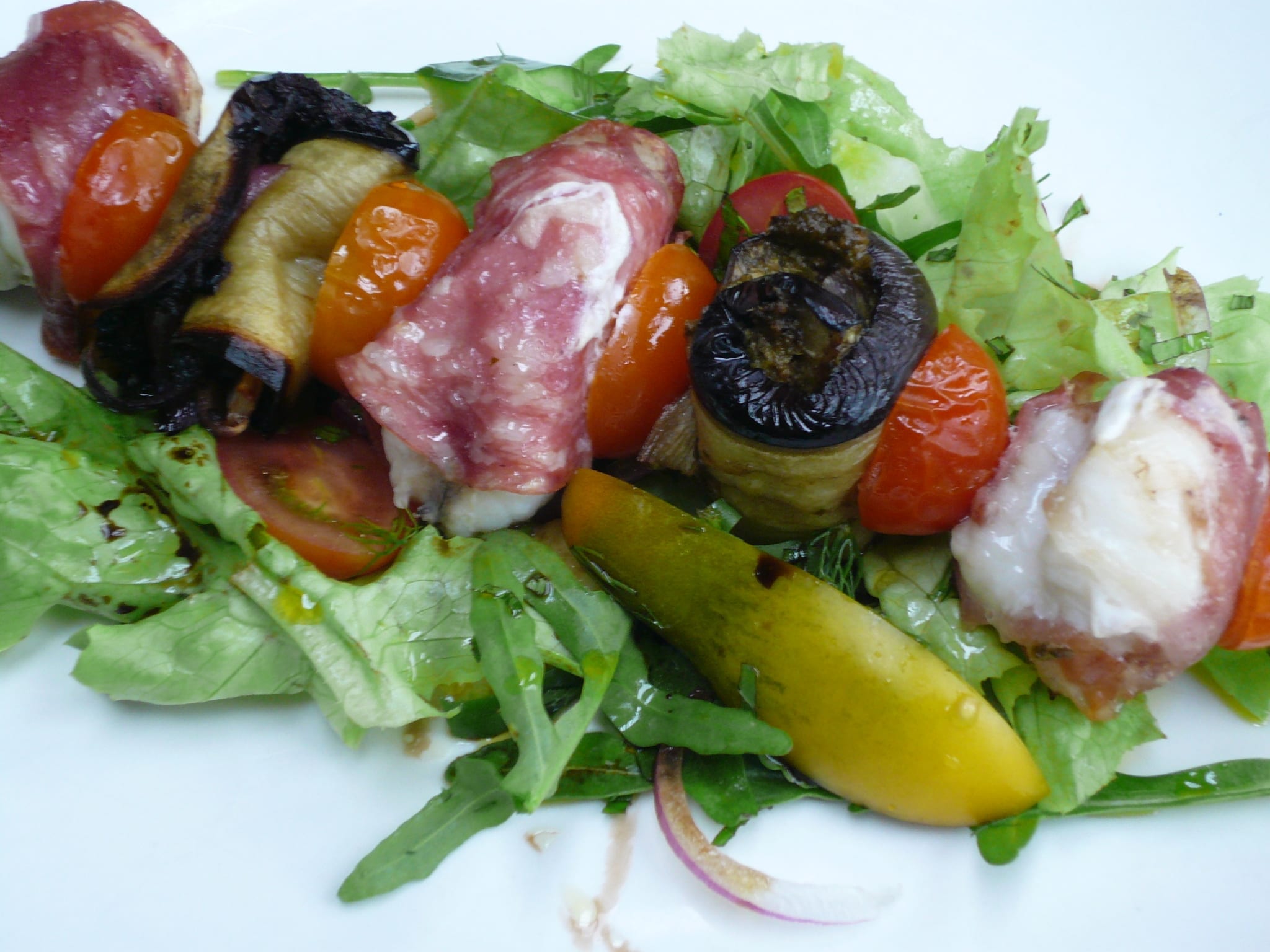 Skewers of monkfish pieces wrapped in parma ham & cooked with grilled aubergine & cherry tomatoes.