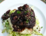 A dish of ox cheek served on a bed of cabbage & mash