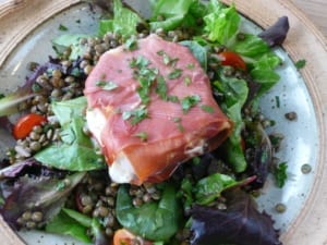 picture of goats cheese baked in Proscuitto with Puy Lentils and served on a bed of salad