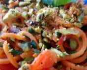 A bowl of spiralised sweet potato with tomato and pistachio nut sauce