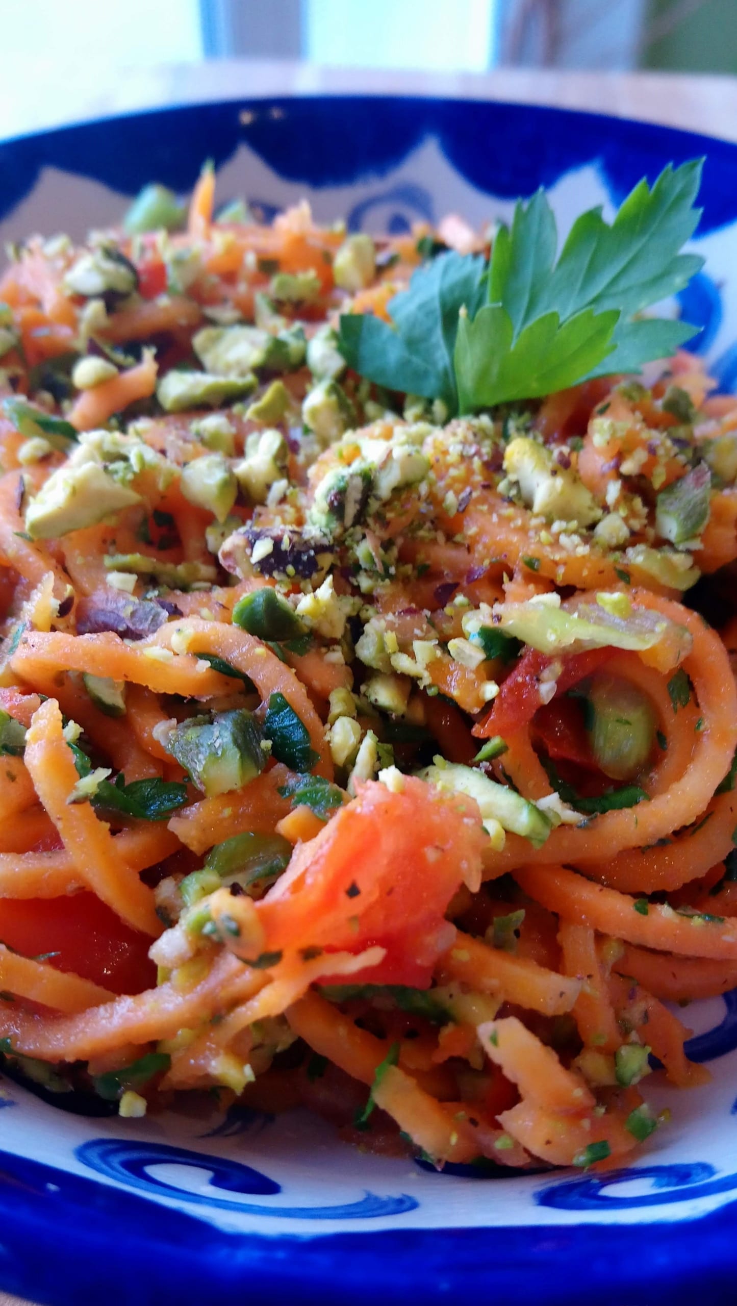 A bowl of spiralised sweet potato with tomato and pistachio nut sauce