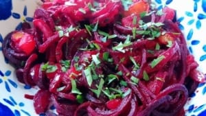A bowl of spiralised beetroot with chorizo, tomato & red onion sauce