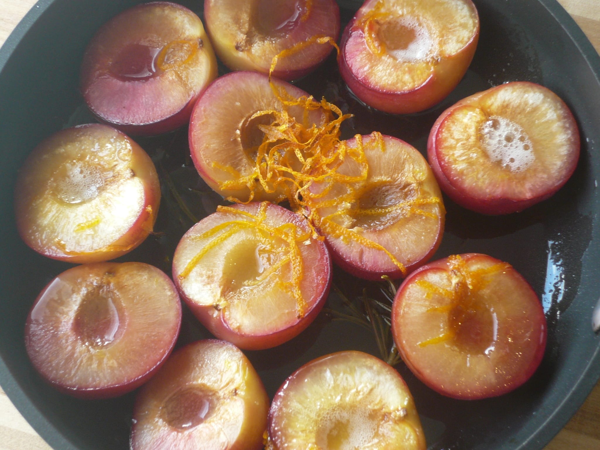 Halved plums roasted with orange rind, juice & rosemary