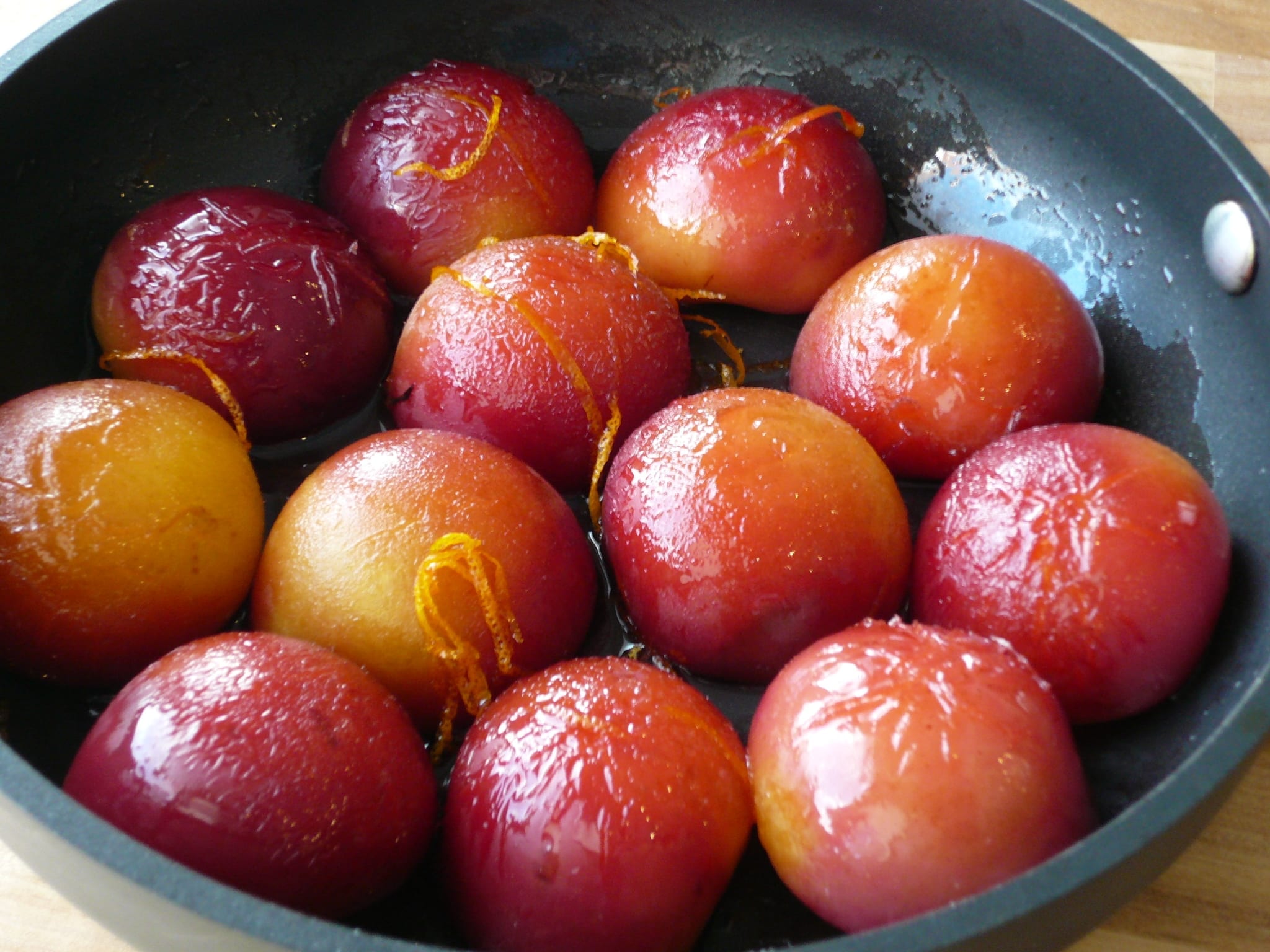 Halved roasted plums, skin side up
