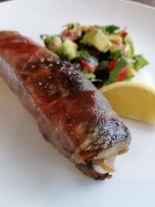 Fried herring stuffed with onion and dill, wrapped in proscuitto