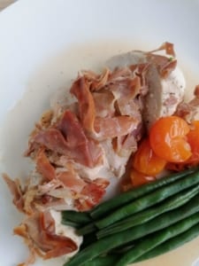 Baked chicken breast cooked with prosciutto and cherry tomatoes