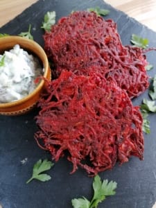 Beetroot fritters served with a pot of cucumber raita