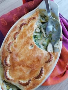 Chicken, leek & parsley pie with a portion removed