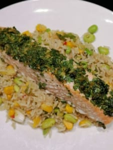 Fillet of salmon topped with a lime, ginger and coriander crust, served on a bed of steamed vegetable rice.