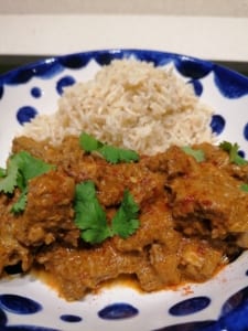 A dish of lamb curry served with rice