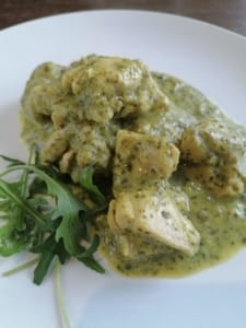 A dish of chicken with a leek and watercress sauce