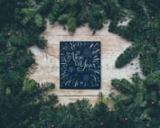 New year plaque surrounded by pine branches