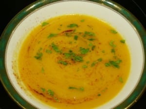 A bowl of sweet potato soup swirled with smoked paprika, coriander & chilli oil