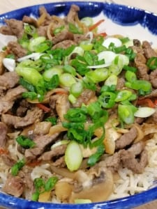 A bowl of stir fried beef with mushrooms and chilli