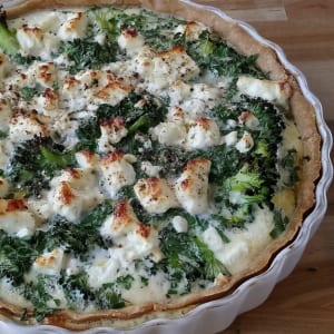 An image of a broccoli, herb and feta cheese quiche