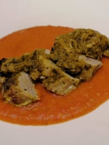 A dish of chermoula marinated pork fillet, served with a tomato sauce