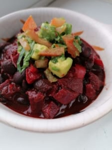 A dish of Black Bean Chilli with a garnish of tomato & avocado salsa