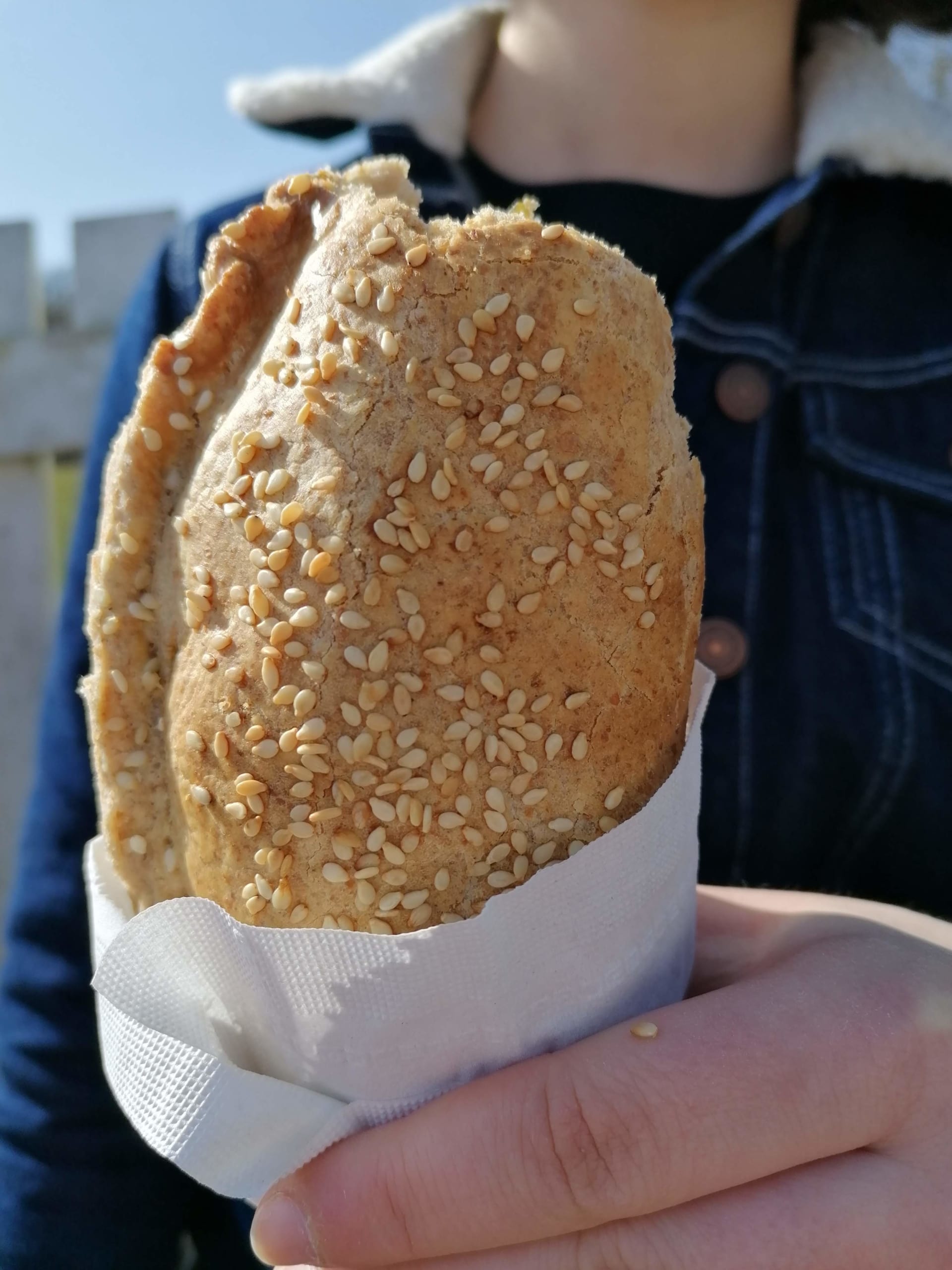 An image of a pasty being eaten on a picnic