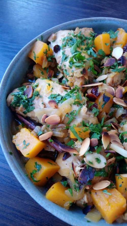 An image of a dish of chicken tagine with butternut squash and almonds