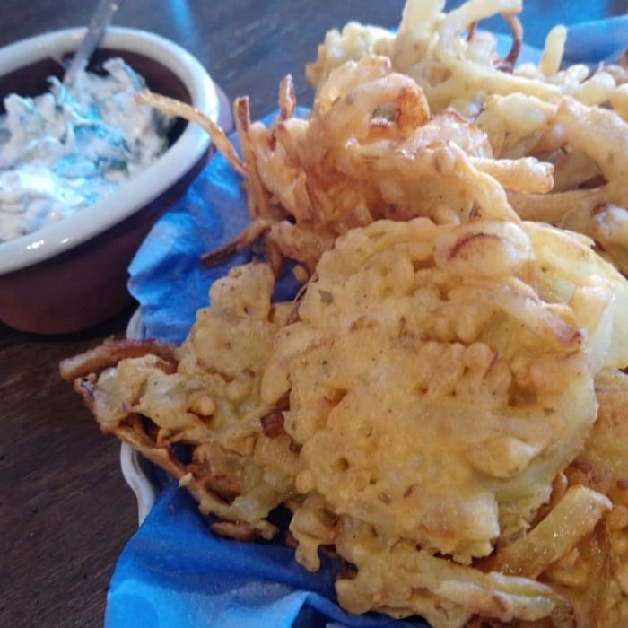 A bowl of onion bhajis with cucumber raita