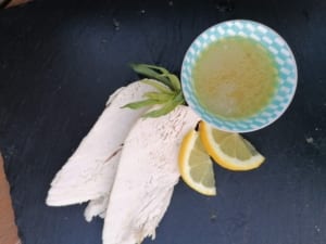 An image of sliced breast of chicken with lemon & tarragon sauce