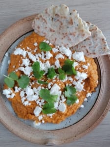 an image of butternut squash hummus with seeded flatbread
