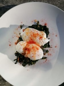 An image of Chinese style kale with poached eggs on sourdough bread