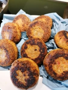 An image of fried nut rissoles, draining on kitchen paper, ready to eat.