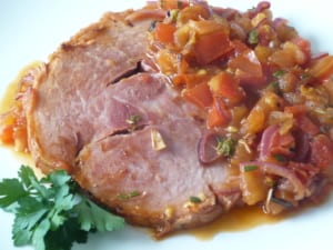 an image of a ham steak with tomato & herb sauce with