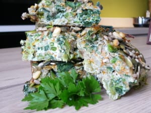 an image of a stack of pieces of leek, spinach herb & feta pie
