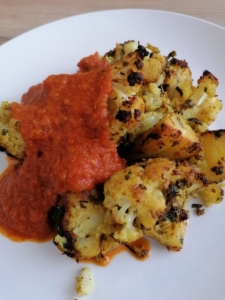 an image of spice baked cauliflower with tomato sauce