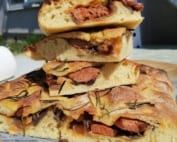 An image of a stack of stuffed focaccia slices