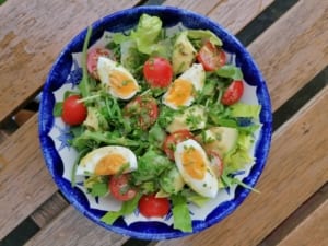 A bowl of avocado and soft boiled egg salad