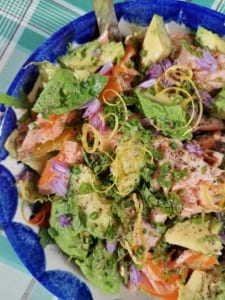 An image of a bowl of hot smoked salmon and avocado salad