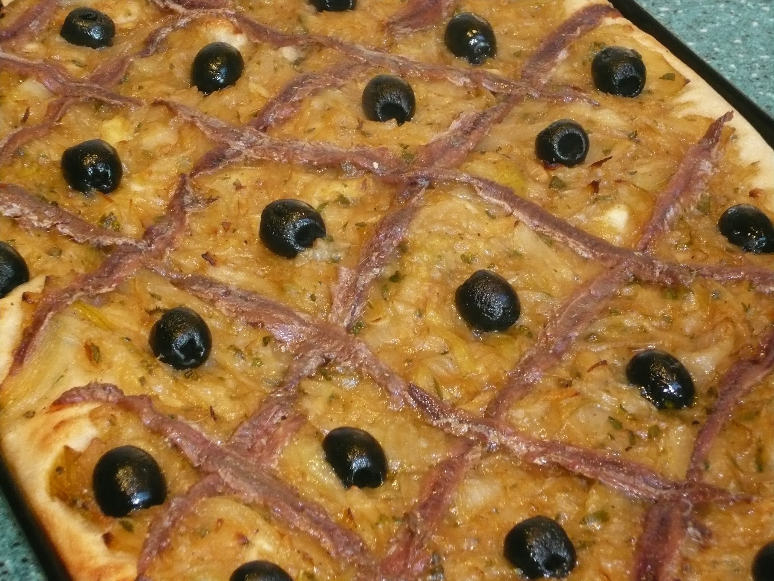 An image of a tray of pissaladiere