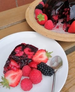 An image of a slice of gluten free summer pudding served with summer fruits