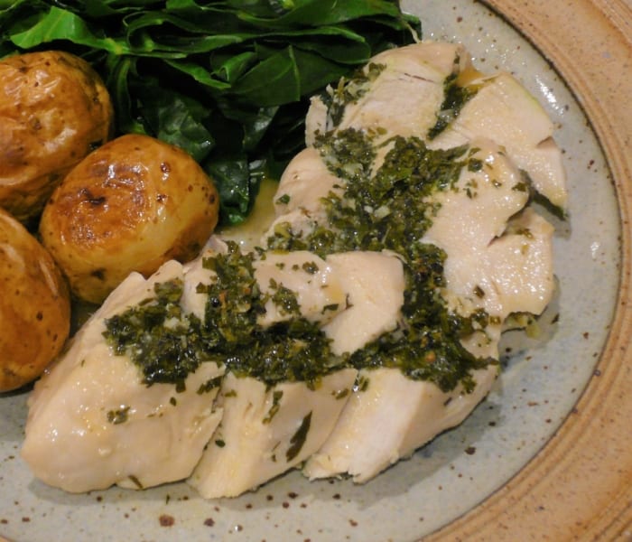 A dish of garlic & herb chicken with oven roast potatoes & greens
