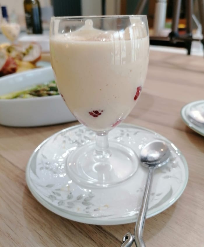 an image of zabaglione served with fresh raspberries